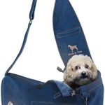 Dog peeking from blue shoulder bag.