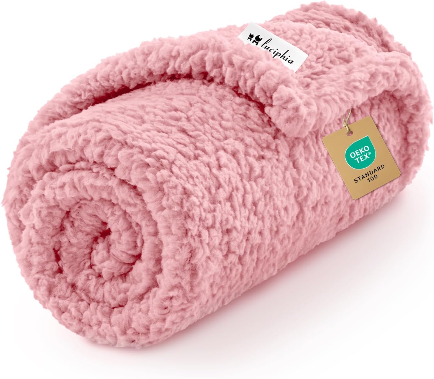 Pink rolled fluffy blanket with Oeko-Tex tag.