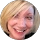 Smiling person with short blonde hair.