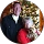Couple smiling in front of Christmas tree.