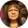 Woman wearing glasses, indoors, neutral expression.