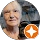 Elderly woman with a star-shaped badge.